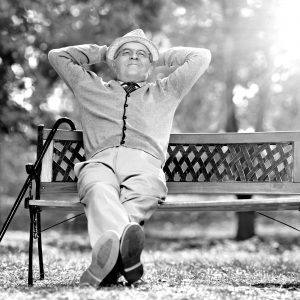 Happy senior on park bench