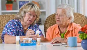 Helping a senior by marking their medication