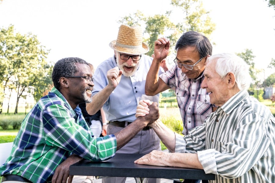 Senior men playing games together for well-being