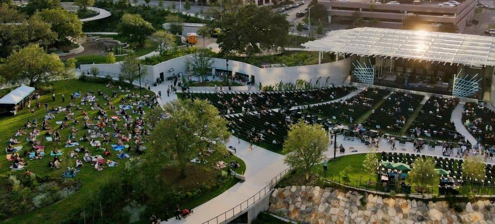 Waterloo Square and Park with picnic area and people enjoying music in the outdoor theatre.