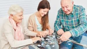  Friends and family getting together to engage in tactile connections by building a puzzle.