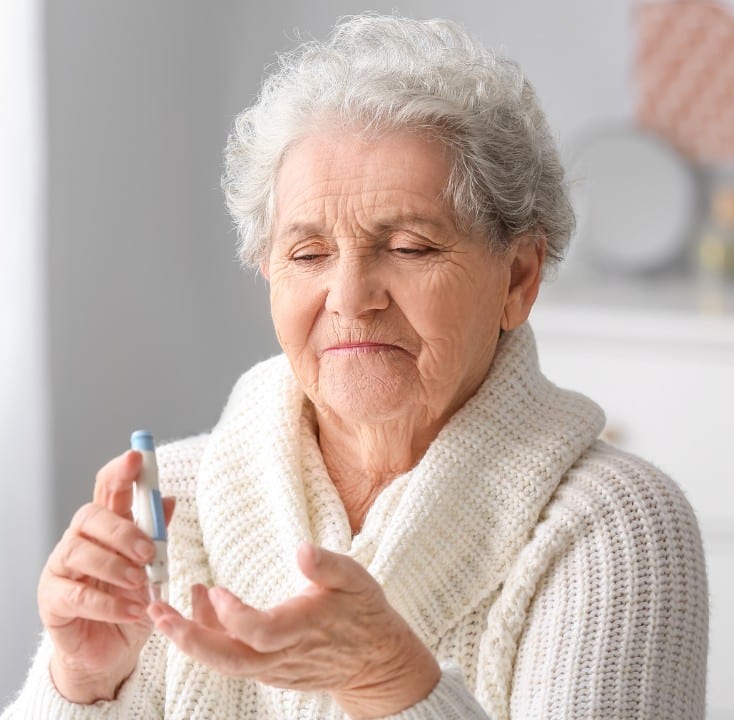 Senior testing her insulin levels which is critical with Type 2 Diabetes. Promyse Home Care offers medication management to offer peace of mind.