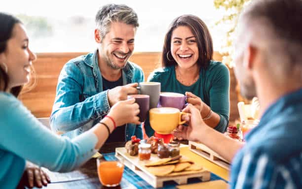 Family and friends relaxing over coffee to reduce stress