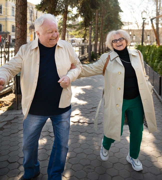 Couple helping each other exercise by walking after Hip Replacement Surgery