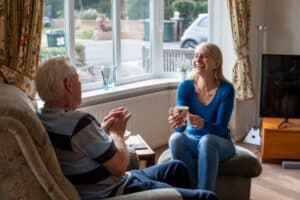 Promyse Home Caregiver engaging in fun conversation with their client,