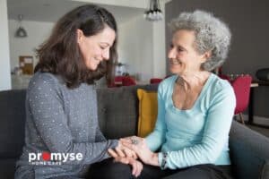 Compassionate caregiver providing companionship and comfort to a senior woman at home.