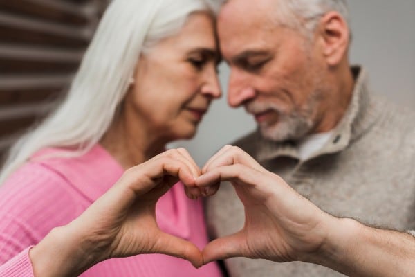 Senior Couple loving each other and watching the warning signs of a heart attack