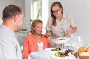 Satisfied senior couple in their home with caregiver.