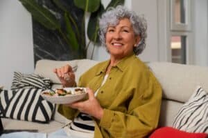 Happy Senior woman able to age with dignity in her own home thanks to planning and assistance from Promyse Home Care.