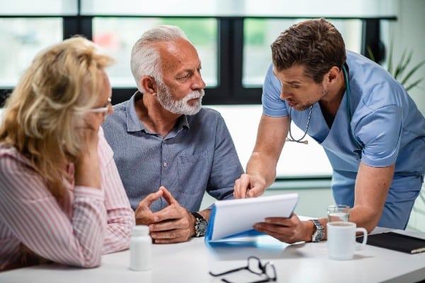 seniors consult with doctor on dementia diagnosis.