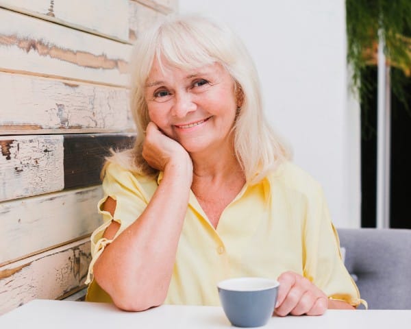 Senior woman happy to be aging in the comfort of her own home.