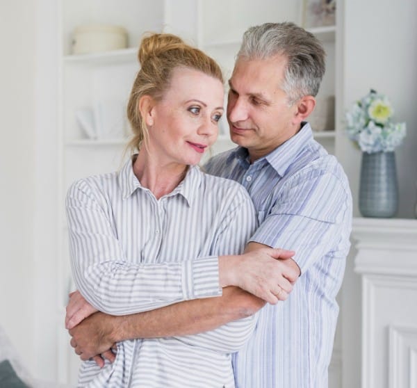 Loving partner listening to his loved one with early signs of Dementia