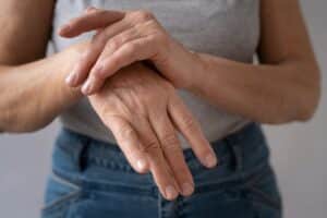 Senior women with arthritis in her joints causing pain