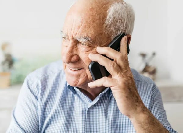 Senior Man talking to a counselor at the Seniors Safety Line to discuss resources for help