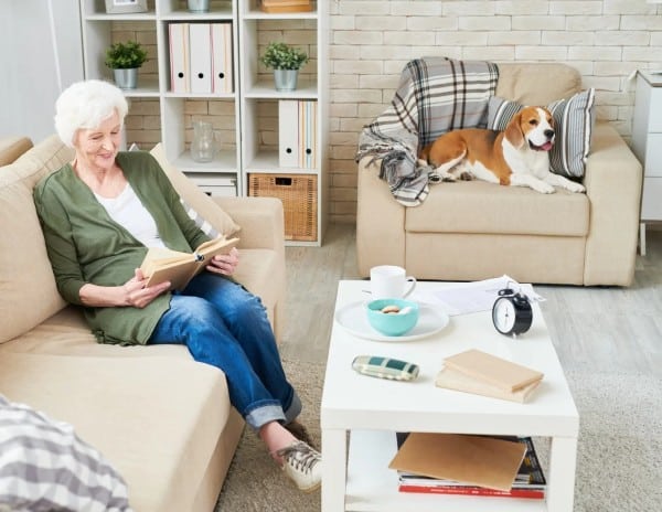 Senior woman aging in place in her home with her dog