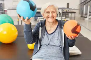 Senior woman enjoying exercise and physiotherapy at LiveWell Health for better movement and pain reduction.