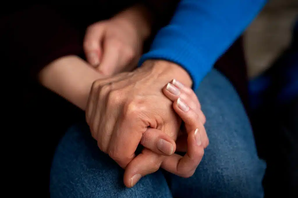 Holding hands for support of each other is the caregivers way of helping loved ones.