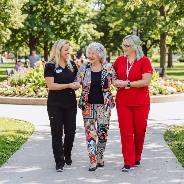 Promyse Nurses helping Senior woman go for a walk